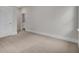 Empty bedroom with a neutral carpet, white door, and trim, creating a bright and airy atmosphere at 3027 Robeson Trce, Johns Island, SC 29455
