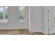 Bright entryway with hardwood floors, white trim, and natural light from the window at 3027 Robeson Trce, Johns Island, SC 29455