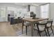 Modern kitchen and dining area with stainless steel appliances, island, and stylish table at 3027 Robeson Trce, Johns Island, SC 29455