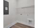 Functional laundry room with laminate floors, shelving, and utility connections at 3027 Robeson Trce, Johns Island, SC 29455
