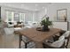 Open-concept living room with hardwood floors, bright decor, and a decorative plant centerpiece at 3027 Robeson Trce, Johns Island, SC 29455