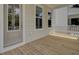 Inviting porch with wood flooring, bright windows, and neutral colored siding at 3027 Robeson Trce, Johns Island, SC 29455