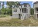 A well-maintained two-story home with stairs leading to the screened-in porch and a lush backyard at 3041 Robeson Trce, Johns Island, SC 29455