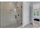 Modern bathroom with a glass shower and view into the bedroom at 3041 Robeson Trce, Johns Island, SC 29455