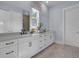 Bathroom with double vanity, white cabinets, modern faucets, and tiled floors at 3041 Robeson Trce, Johns Island, SC 29455