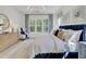 Comfortable bedroom featuring a large window, blue headboard, and elegant chandelier at 3041 Robeson Trce, Johns Island, SC 29455