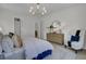 Well-lit bedroom with a blue bed, white walls, rug, dresser, and sitting chair at 3041 Robeson Trce, Johns Island, SC 29455