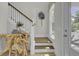 Inviting entryway with wood stairs, unique console table and decor, offering a glimpse of the home's interior design at 3041 Robeson Trce, Johns Island, SC 29455