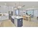 Open-concept kitchen features stainless steel appliances, a central island with seating, and modern lighting at 3041 Robeson Trce, Johns Island, SC 29455