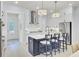 Well-lit kitchen with a modern island, stainless steel appliances, and stylish white cabinetry at 3041 Robeson Trce, Johns Island, SC 29455