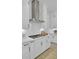 Well-appointed kitchen with stainless steel range hood, white cabinetry, and modern tile backsplash at 3041 Robeson Trce, Johns Island, SC 29455
