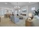Open concept living room with dining area features white accents and lots of natural light from large windows at 3041 Robeson Trce, Johns Island, SC 29455