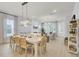 Bright open-concept living area with dining table and chairs, fireplace, and light hardwood floors at 3041 Robeson Trce, Johns Island, SC 29455