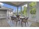 Covered patio features an outdoor dining table, seating area, and views of the surrounding landscape at 3041 Robeson Trce, Johns Island, SC 29455