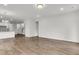 Open-concept living space with hardwood floors, recessed lighting, and a view of the modern kitchen area at 322 Abercom Place Dr, Moncks Corner, SC 29461