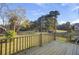 An inviting wood deck overlooking a spacious yard and green trees, perfect for relaxation at 422 Caledon Ct, Johns Island, SC 29455