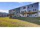 The backyard showing a row of townhomes with decks, offering green space at 422 Caledon Ct, Johns Island, SC 29455