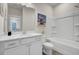 Bright bathroom featuring white cabinetry, solid surface countertops, and a tub with a shower in a tiled surround at 422 Caledon Ct, Johns Island, SC 29455