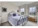 Charming bedroom features a black metal bed frame, soft blue bedding, and bright natural light from the windows at 422 Caledon Ct, Johns Island, SC 29455