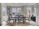 Well-lit dining room with hardwood floors, large windows, and stylish decor at 422 Caledon Ct, Johns Island, SC 29455