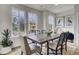 Bright dining area features hardwood floors, large windows, modern decor and view to the outside at 422 Caledon Ct, Johns Island, SC 29455
