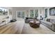 Bright living room with large windows, comfortable seating, and stylish decor at 422 Caledon Ct, Johns Island, SC 29455