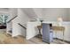 Bright home office space featuring hardwood floors, staircase, and a modern wooden desk setup at 422 Caledon Ct, Johns Island, SC 29455
