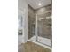 Contemporary bathroom with an enclosed shower featuring gray tile and glass doors at 422 Caledon Ct, Johns Island, SC 29455
