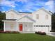 Charming two-story home featuring a bright red front door, attached two-car garage, and landscaped yard at 422 Radiant Blue Way, Summerville, SC 29486