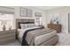 Comfortable primary bedroom features a wooden bed frame, neutral walls, and cozy decor at 422 Radiant Blue Way, Summerville, SC 29486