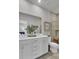 Bright bathroom features double vanity, framed mirror, and tile shower with a wooden bench at 424 Caledon Ct, Johns Island, SC 29455