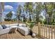 Spacious deck with outdoor seating, wooden railings, and lush backyard views, perfect for relaxation at 424 Caledon Ct, Johns Island, SC 29455