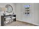 Inviting entryway features a stylish console table, round mirror, and a glimpse of the outdoors at 424 Caledon Ct, Johns Island, SC 29455