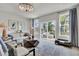 Airy living room featuring a modern geometric table, plush seating, and access to outdoor deck at 424 Caledon Ct, Johns Island, SC 29455