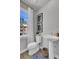 Compact powder room with pedestal sink, modern fixtures, and natural light from the window at 424 Caledon Ct, Johns Island, SC 29455