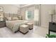 The main bedroom features a decorative headboard, soft lighting, and a wall of windows at 424 Radiant Blue Way, Summerville, SC 29486