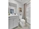 Bright bathroom featuring a toilet, single sink vanity, framed mirror, and a shower with a striped curtain at 477 Caledon Ct, Johns Island, SC 29455