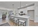 Open-concept kitchen features stainless appliances, white cabinets, quartz counters, a dining area, and an island at 477 Caledon Ct, Johns Island, SC 29455