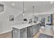 Kitchen island with seating, quartz counters, stainless dishwasher, sink and black faucet at 477 Caledon Ct, Johns Island, SC 29455