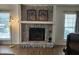 Cozy living area highlighting a stone fireplace with mantle, flanked by light-filled windows at 514 Woodward Blvd, Summerville, SC 29483