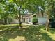 Charming home with a well-manicured lawn, mature trees, and a welcoming facade at 514 Woodward Blvd, Summerville, SC 29483