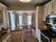 Bright kitchen offering granite counters, white cabinetry, and a view into the dining area at 514 Woodward Blvd, Summerville, SC 29483