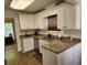 Well-lit kitchen with granite counters and white cabinets at 514 Woodward Blvd, Summerville, SC 29483