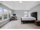 Bright bedroom with a vaulted ceiling, large windows, and a desk area that offers a comfortable and functional space at 5289 Mulholland Dr, Summerville, SC 29485