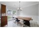 Dining room featuring large windows, decorative molding, and a rustic wooden table at 5289 Mulholland Dr, Summerville, SC 29485