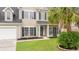 Close-up of a home's front exterior showing manicured lawn and black shuttered windows at 5289 Mulholland Dr, Summerville, SC 29485