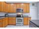 Well-equipped kitchen featuring stainless steel appliances, plenty of counter space, and wooden cabinets at 5289 Mulholland Dr, Summerville, SC 29485