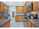 Spacious kitchen with stainless steel appliances and wood cabinetry, perfect for cooking and entertaining at 5289 Mulholland Dr, Summerville, SC 29485