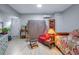 Cozy living area with a red cushioned chair, wooden accents, and light, modern flooring at 5289 Mulholland Dr, Summerville, SC 29485