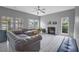 Bright living room with a fireplace, large windows, and stylish leather seating for relaxing at 5289 Mulholland Dr, Summerville, SC 29485